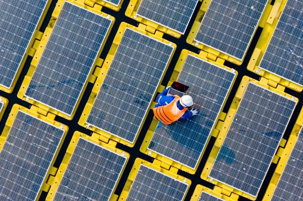 Floating solar panels providing renewable energy. Aerial view floating on solar cells and
