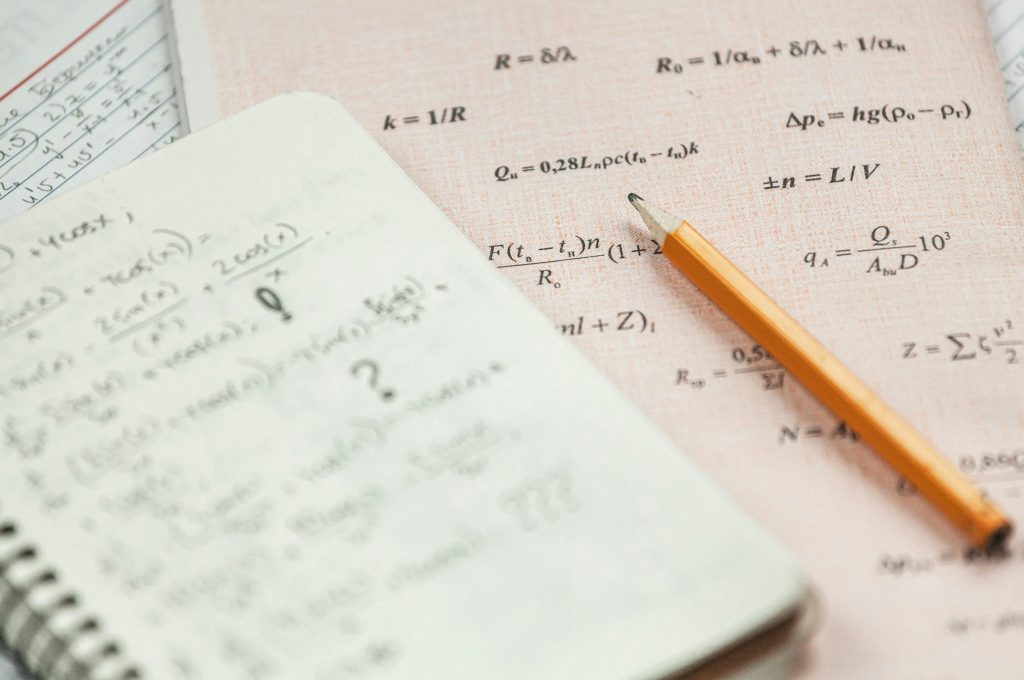 Math formulas are written in pencil on a piece of paper, math pr