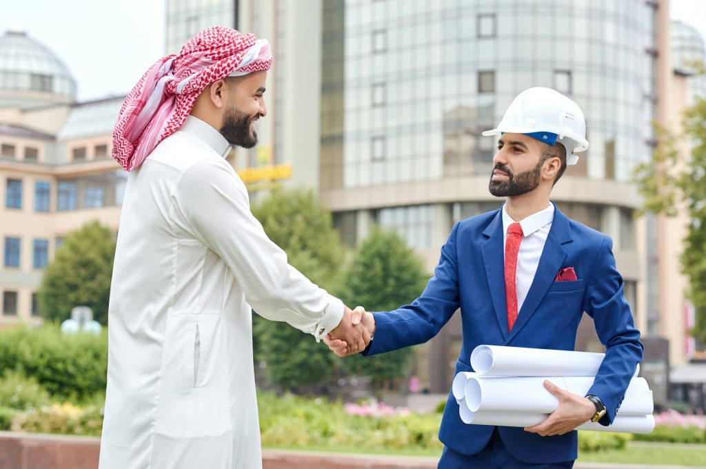 Professional engineer shaking hands with his client